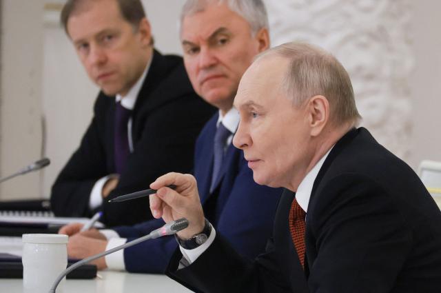 In this pool photograph distributed by the Russian state agency Sputnik, Russia's President Vladimir Putin chairs a State Council meeting at the Kremlin in Moscow on December 25, 2025. (Photo by Mikhail METZEL / POOL / AFP)