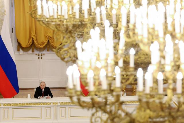 In this pool photograph distributed by the Russian state agency Sputnik, Russia's President Vladimir Putin chairs a State Council meeting at the Kremlin in Moscow on December 25, 2025. (Photo by Alexander KAZAKOV / POOL / AFP)