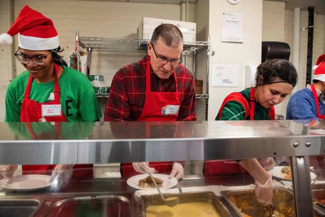 Volunteers plate meals for guests at the St. Francis House, New England’s largest day shelter, on Christmas Day in Boston, Massachusetts, on December 25, 2025. According to a 2025 census done by the city of Boston there are 2,122 single adults experience homelessness in the city. (Photo by Joseph Prezioso / AFP)