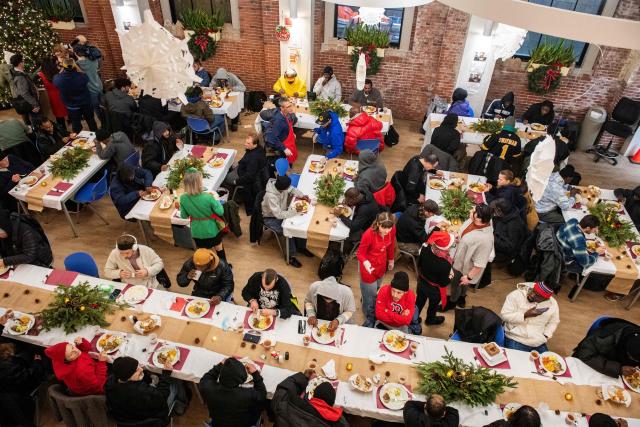 Guests eat their meal at the St. Francis House, New England’s largest day shelter, on Christmas Day in Boston, Massachusetts, on December 25, 2025. According to a 2025 census done by the city of Boston there are 2,122 single adults experience homelessness in the city. (Photo by Joseph Prezioso / AFP)