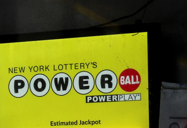 (FILES) A Powerball is displayed at a newsstand on December 23, 2025 in New York City. A lucky lottery player in the US state of Arkansas has won the $1.8 billion Powerball prize, the second-largest US lottery jackpot ever won, the gambling game's organizer said on December 25, 2025. "With final ticket sales, the Powerball jackpot reached $1.817 billion, making it the second-largest US lottery jackpot ever won and the largest Powerball prize this year," Powerball said in a statement. The drawing was held on Christmas Eve. The winner can claim the full amount in 30 annual payments or opt for a one-off cash payout of $834.9 million before tax. (Photo by ANGELA WEISS / AFP)