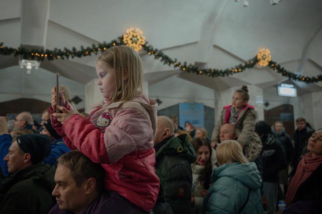 Visitors watch the folk Christmas concert "Kolyada Unites" on Christmas Day in the subway in Kharkiv on December 25, 2025, amid the Russian invasion of Ukraine. (Photo by Ivan SAMOILOV / AFP)