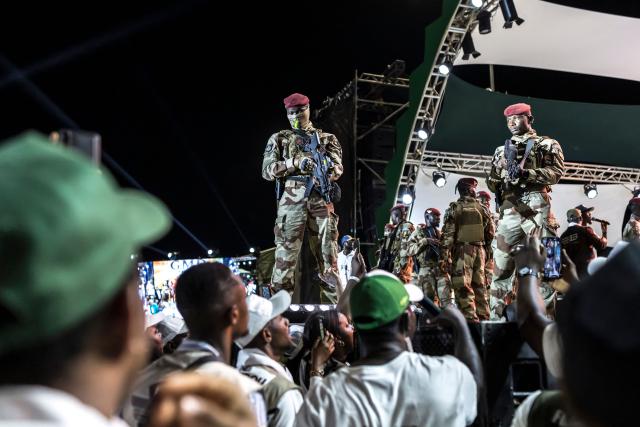 Members of the Guinea Special Forces unit stand guard during the final campaign rally of Guinean President and presidential candidate Mamady Doumbouya ahead of the country's presidential election in Conakry on December 25, 2025. Guinean voters head to the polls for a presidential election on December 28, 2025. (Photo by PATRICK MEINHARDT / AFP)