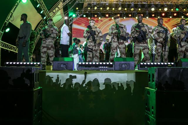 TOPSHOT - Members of the Guinea Special Forces unit stand guard during the final campaign rally of Guinean President and presidential candidate Mamady Doumbouya ahead of the country's presidential election in Conakry on December 25, 2025. Guinean voters head to the polls for a presidential election on December 28, 2025. (Photo by PATRICK MEINHARDT / AFP)