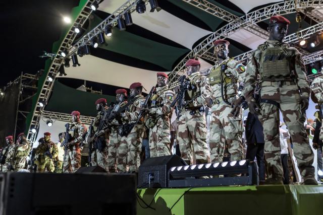 Members of the Guinea Special Forces unit stand guard during the final campaign rally of Guinean President and presidential candidate Mamady Doumbouya ahead of the country's presidential election in Conakry on December 25, 2025. Guinean voters head to the polls for a presidential election on December 28, 2025. (Photo by PATRICK MEINHARDT / AFP)
