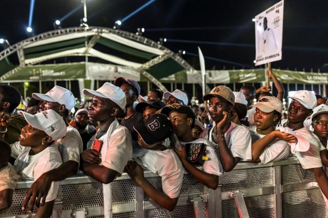 A supporter of Guinean President and presidential candidate Mamady Doumbouya dances during his final campaign rally ahead of the country's presidential election in Conakry on December 25, 2025. (Photo by PATRICK MEINHARDT / AFP)