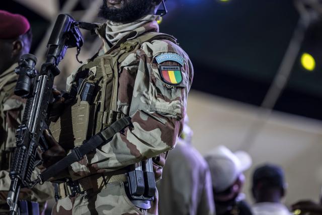 A Special Forces patch is seen on the uniform of a member of the Guinea Special Forces unit during the final campaign rally of Guinean President and presidential candidate Mamady Doumbouya on December 25, 2025. (Photo by PATRICK MEINHARDT / AFP)
