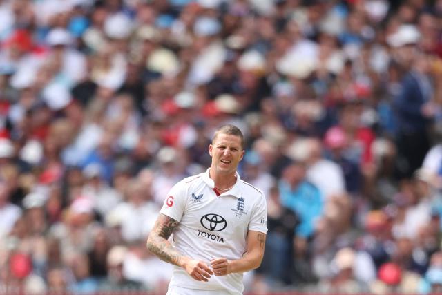 England's Brydon Carse reacts during the first day of the fourth Ashes cricket Test match between Australia and England at the Melbourne Cricket Ground (MCG) in Melbourne on December 26, 2025. (Photo by Martin KEEP / AFP)
