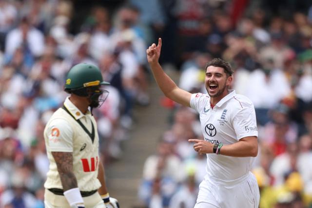 England's Josh Tongue (R) celebrates after dismissing Australia's Jake Weatherald during the first day of the fourth Ashes cricket Test match between Australia and England at the Melbourne Cricket Ground (MCG) in Melbourne on December 26, 2025. (Photo by Martin KEEP / AFP)