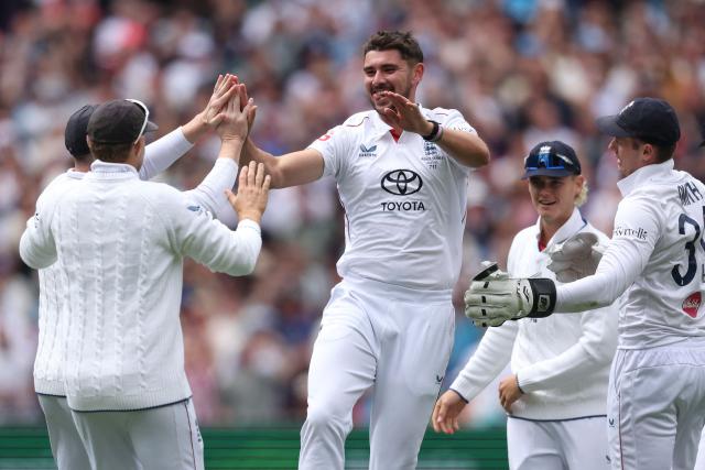 England's Josh Tongue (R) celebrates with teammates after dismissing Australia's Jake Weatherald during the first day of the fourth Ashes cricket Test match between Australia and England at the Melbourne Cricket Ground (MCG) in Melbourne on December 26, 2025. (Photo by Martin KEEP / AFP)