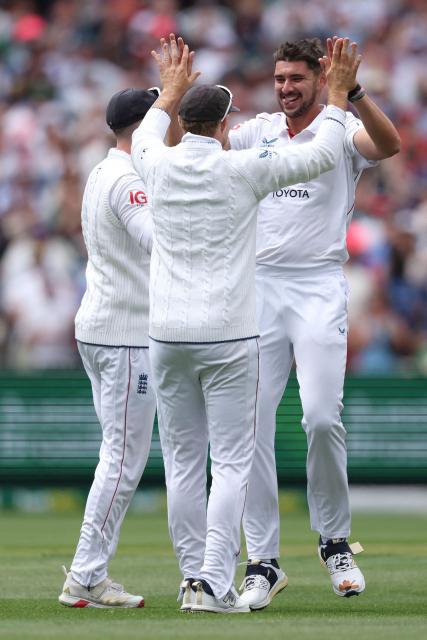 England's Josh Tongue (R) celebrates with teammates after dismissing Australia's Jake Weatherald during the first day of the fourth Ashes cricket Test match between Australia and England at the Melbourne Cricket Ground (MCG) in Melbourne on December 26, 2025. (Photo by Martin KEEP / AFP)