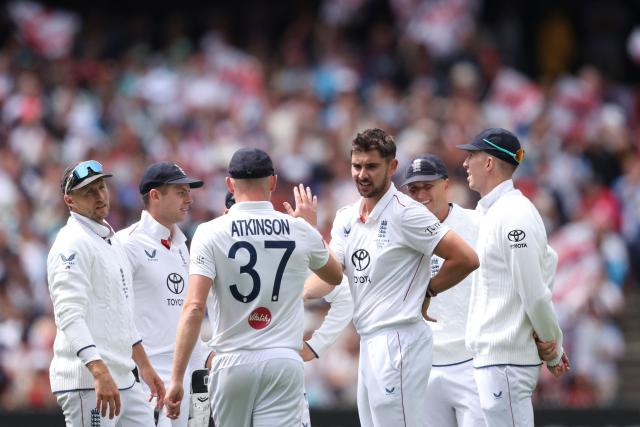 England players celebrate after Josh Tongue takes the wicket of Australia's Jake Weatherald during the first day of the fourth Ashes cricket Test match between Australia and England at the Melbourne Cricket Ground (MCG) in Melbourne on December 26, 2025. (Photo by Martin KEEP / AFP)
