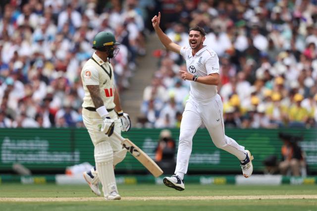 England's Josh Tongue (R) celebrates after dismissing Australia's Jake Weatherald during the first day of the fourth Ashes cricket Test match between Australia and England at the Melbourne Cricket Ground (MCG) in Melbourne on December 26, 2025. (Photo by Martin KEEP / AFP)