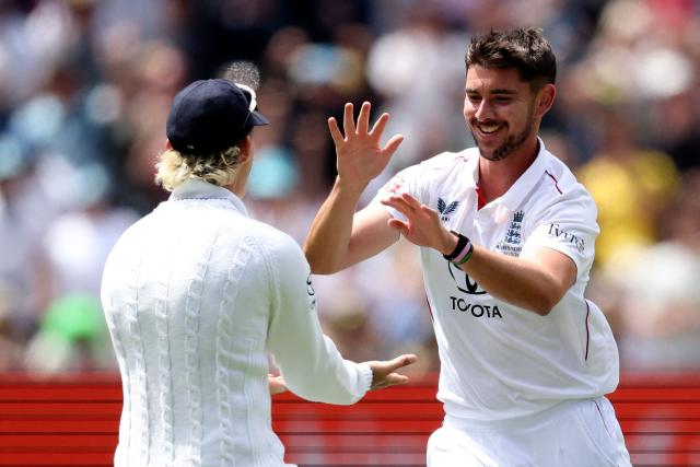 England's Josh Tongue (R) celebrates with Ben Stokes after dismissing Australia's Marnus Labuschagne during the first day of the fourth Ashes cricket Test match between Australia and England at the Melbourne Cricket Ground (MCG) in Melbourne on December 26, 2025. (Photo by Martin KEEP / AFP)
