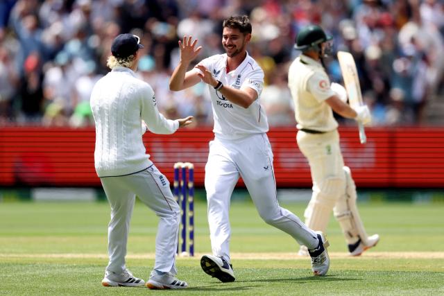 England's Josh Tongue (R) celebrates with Ben Stokes after dismissing Australia's Marnus Labuschagne during the first day of the fourth Ashes cricket Test match between Australia and England at the Melbourne Cricket Ground (MCG) in Melbourne on December 26, 2025. (Photo by Martin KEEP / AFP)