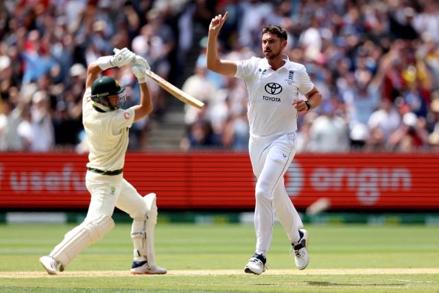 England's Josh Tongue (R) celebrates after dismissing Australia's Marnus Labuschagne during the first day of the fourth Ashes cricket Test match between Australia and England at the Melbourne Cricket Ground (MCG) in Melbourne on December 26, 2025. (Photo by Martin KEEP / AFP)