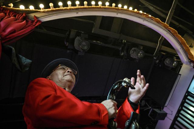 This photo taken on December 10, 2025 shows a musician playing at the Hai Shang Jiu Meng Dance Hall in the Changning district of Shanghai. It was just a regular Wednesday at a lunchtime dance club in Shanghai, where dance hall culture has been deeply rooted in the city's identity since its jazz-age heyday. On any given day, multiple venues host hours-long daytime sessions across the finance hub, some starting as early as 6 am. Establishments like the historic Paramount Ballroom are time capsules from the 1930s, while others flash with neon pink and green rave lights in the early afternoon. (Photo by Hector RETAMAL / AFP) / To go with 'CHINA-LIFESTYLE-DANCE-HISTORY-DEMOGRAPHICS, REPORTAGE' by Rita QIAN