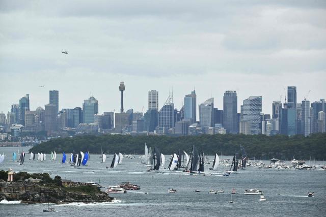 Yachts compete at the start of the annual Sydney to Hobart yacht race on Boxing Day at Sydney Harbour on December 26, 2025. (Photo by Saeed KHAN / AFP)