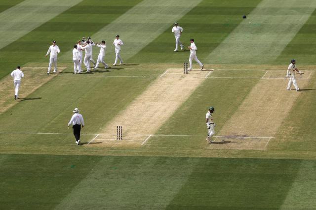 England's players celebrate the wicket of Australia's Travis Head during the first day of the fourth Ashes cricket Test match between Australia and England at the Melbourne Cricket Ground (MCG) in Melbourne on December 26, 2025. (Photo by Martin KEEP / AFP)