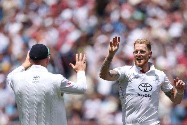 England's Ben Stokes (L) celebrates the wicket of Australia's Alex Carey with Zak Crawley during the first day of the fourth Ashes cricket Test match between Australia and England at the Melbourne Cricket Ground (MCG) in Melbourne on December 26, 2025. (Photo by Martin KEEP / AFP)