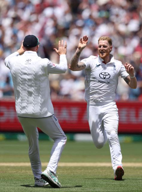 England's Ben Stokes (L) celebrates the wicket of Australia's Alex Carey with Zak Crawley during the first day of the fourth Ashes cricket Test match between Australia and England at the Melbourne Cricket Ground (MCG) in Melbourne on December 26, 2025. (Photo by Martin KEEP / AFP)