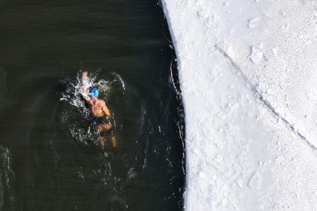 A winter swimming enthusiast participates in a winter swimming event at the Shenshuiwan park in Liaoning, northeastern China's Liaoning province, on December 25, 2025. (Photo by AFP) / China OUT