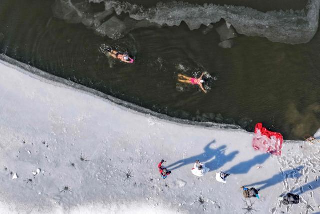 Swimming enthusiasts participate in a winter swimming event at the Shenshuiwan park in Liaoning, northeastern China's Liaoning province, on December 25, 2025. (Photo by AFP) / China OUT