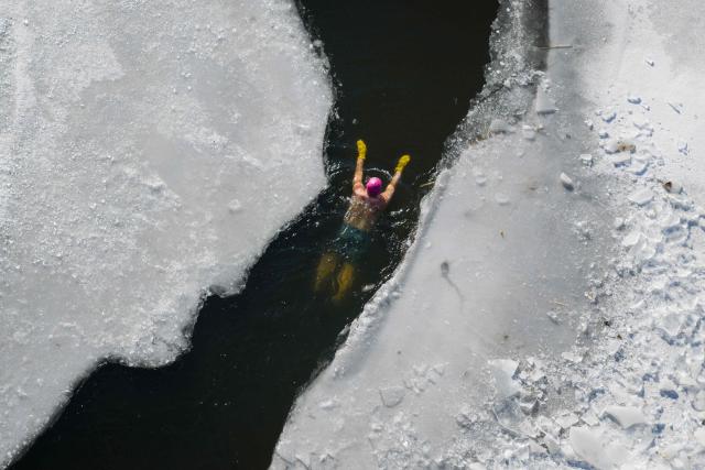 A winter swimming enthusiast participates in a winter swimming event at the Shenshuiwan park in Liaoning, northeastern China's Liaoning province, on December 25, 2025. (Photo by AFP) / China OUT