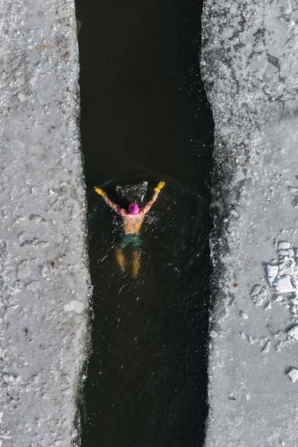 A winter swimming enthusiast participates in a winter swimming event at the Shenshuiwan park in Liaoning, northeastern China's Liaoning province, on December 25, 2025. (Photo by AFP) / China OUT