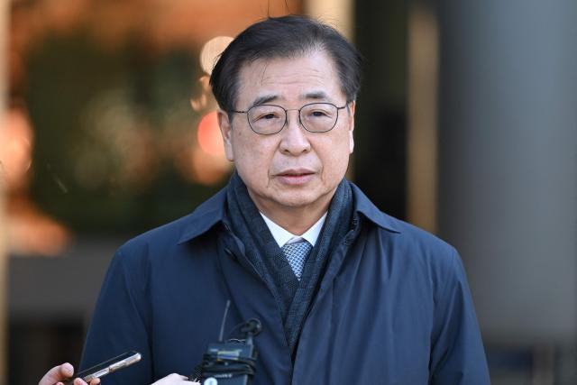 Suh Hoon, former national security chief under ex-president Moon Jae-in, speaks to reporters as he leaves after a trial related to the killing of a fisheries official near the inter-Korean sea border in 2020, at the Seoul Central District Court in Seoul on December 26, 2025. A South Korean court acquitted on December 26, a former top security adviser and other senior officials over the alleged cover-up of the 2020 killing of a fisheries official by Pyongyang. (Photo by Jung Yeon-je / AFP)