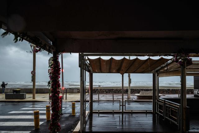 This photograph shows the seafront and beach promenade with waves at Canet en Roussillon in the Pyrenees-Orientales department in the south-west of France on December 26, 2025. Currently under a Meteo France alert, the Pyrenees Orientales are experiencing flooding and rainfall of more than 200mm per hour across the department. (Photo by Jean-Christophe MILHET / AFP)