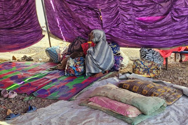 A young displaced Sudanese girl reacts after spending a night with others in Gedaref city eastern Sudan on December 26, 2025 after the Rapid Support Forces (RSF) took control of the Heglig area in western Sudan. Since its outbreak in April 2023, the war between Sudan's army and the paramilitary Rapid Support Forces (RSF) has killed tens of thousands of people and displaced nearly 12 million. At the end of October, the paramilitary group seized control El-Fasher, the conclusion of a bitter 18-month siege for the strategic hub in western Sudan's Darfur region and marked by reports of mass killings and sexual violence. (Photo by AFP)