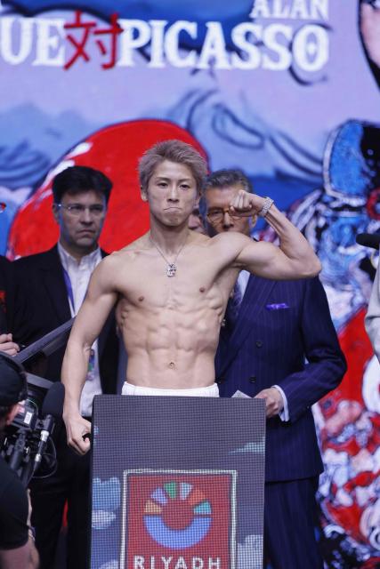 Japan's boxer Naoya Inoue poses on the scale during their weigh-in with Mexico's boxer David Picasso (unseen) on December 26, 2025, in Boulevard Entertainment City in Riyadh, ahead of their final major fight card of the year presented by Riyadh season intitle “The Ring V night of Samurai”. The fight will take place at the Mohammed Abdo Arena, in Riyadh on December 27, 2025. (Photo by Fayez NURELDINE / AFP)