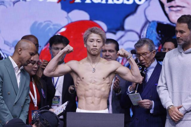Japan's boxer Naoya Inoue poses on the scale during their weigh-in with Mexico's boxer David Picasso (unseen) on December 26, 2025, in Boulevard Entertainment City in Riyadh, ahead of their final major fight card of the year presented by Riyadh season intitle “The Ring V night of Samurai”. The fight will take place at the Mohammed Abdo Arena, in Riyadh on December 27, 2025. (Photo by Fayez NURELDINE / AFP)