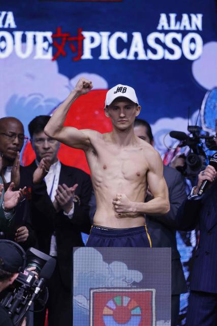 Mexico's boxer David Picasso poses on the scale during their weigh-in with Japan's boxer Naoya Inoue (unseen) on December 26, 2025, in Boulevard Entertainment City in Riyadh, ahead of their final major fight card of the year presented by Riyadh season intitle “The Ring V night of Samurai”. The fight will take place at the Mohammed Abdo Arena, in Riyadh on December 27, 2025. (Photo by Fayez NURELDINE / AFP)