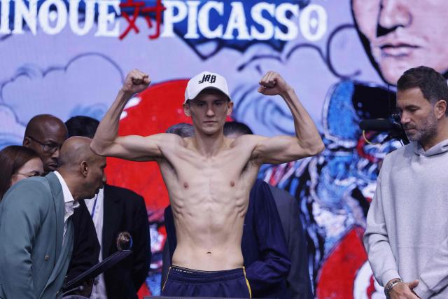 Mexico's boxer David Picasso poses on the scale during their weigh-in with Japan's boxer Naoya Inoue (unseen) on December 26, 2025, in Boulevard Entertainment City in Riyadh, ahead of their final major fight card of the year presented by Riyadh season intitle “The Ring V night of Samurai”. The fight will take place at the Mohammed Abdo Arena, in Riyadh on December 27, 2025. (Photo by Fayez NURELDINE / AFP)