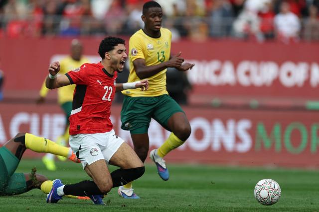 Egypt's forward #22 Omar Marmoush is fouled during the Africa Cup of Nations (CAN) Group B football match between Egypt and South Africa at Adrar Stadium in Agadir on December 26, 2025. (Photo by FRANCK FIFE / AFP)