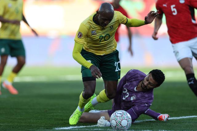 South Africa's defender #20 Khuliso Mudau and Egypt's goalkeeper #16 Mohamed El Shenawy collide during the Africa Cup of Nations (CAN) Group B football match between Egypt and South Africa at Adrar Stadium in Agadir on December 26, 2025. (Photo by FRANCK FIFE / AFP)