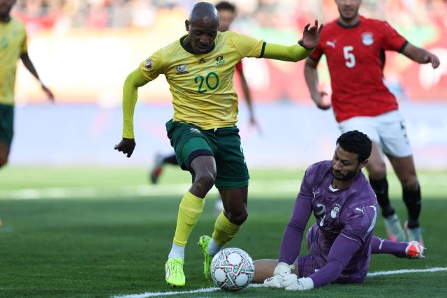 South Africa's defender #20 Khuliso Mudau and Egypt's goalkeeper #16 Mohamed El Shenawy collide during the Africa Cup of Nations (CAN) Group B football match between Egypt and South Africa at Adrar Stadium in Agadir on December 26, 2025. (Photo by FRANCK FIFE / AFP)