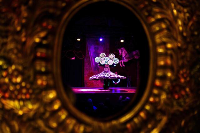 Ibrahim Hassan performs during the annual Festival du Merveilleux at the Musee des Arts Forains in Paris on December 26, 2025. (Photo by Dimitar DILKOFF / AFP)