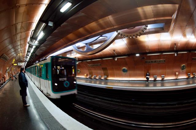 (FILES) This photograph shows a train arriving at the 'Arts et Metiers' metro station in Paris on November 28, 2012. Three women were stabbed and wounded at three different Paris Metro stations, including Opera, Arts et Metiers and Republique, on December 26, 2025, by an attacker who is still at large said the RATP, the body that runs the network. (Photo by PATRICK KOVARIK / AFP)