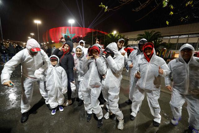 Supporters wear rainproof suits ahead of the Africa Cup of Nations (CAN) Group A football match between Morocco and Mali at Prince Moulay Abdellah Stadium in Rabat on December 26, 2025. (Photo by Abdel Majid BZIOUAT / AFP)