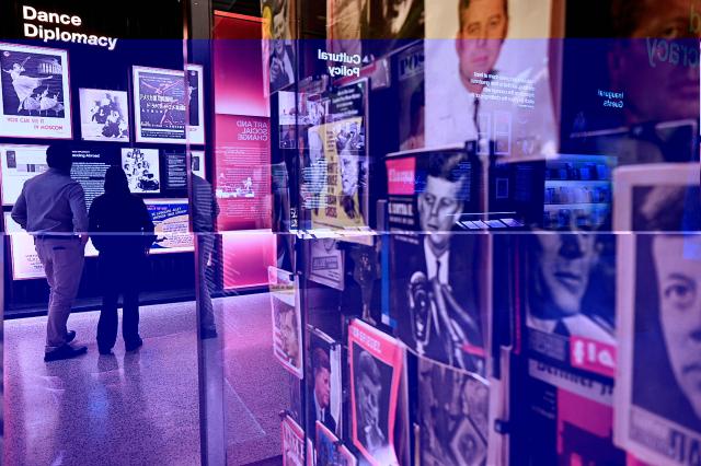 People view an exhibit of former US President John F. Kennedy at the John F. Kennedy Center for the Performing Arts, which was recently renamed the "Trump Kennedy Center," in Washington, DC,  on December 26, 2025. US President Donald Trump's name was affixed to the Kennedy Center in Washington on December 19, 2025, one day after his hand-picked board members voted to rename the arts venue in spite of legal questions. (Photo by Brendan Smialowski / AFP)