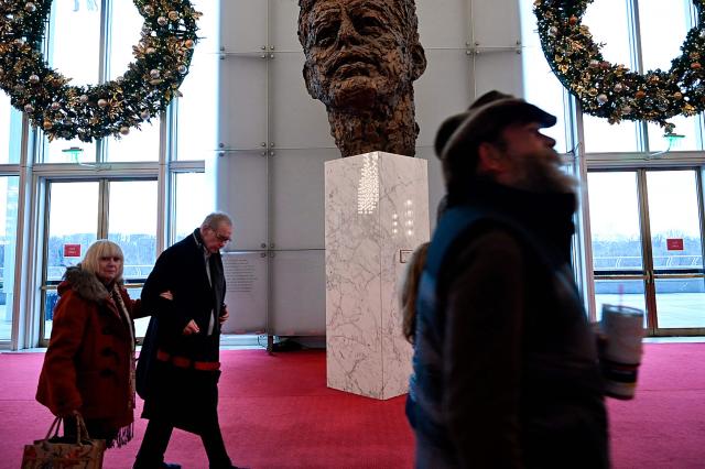 People visit the John F. Kennedy Center for the Performing Arts, which was recently renamed the "Trump Kennedy Center," in Washington, DC,  on December 26, 2025. US President Donald Trump's name was affixed to the Kennedy Center in Washington on December 19, 2025, one day after his hand-picked board members voted to rename the arts venue in spite of legal questions. (Photo by Brendan Smialowski / AFP)