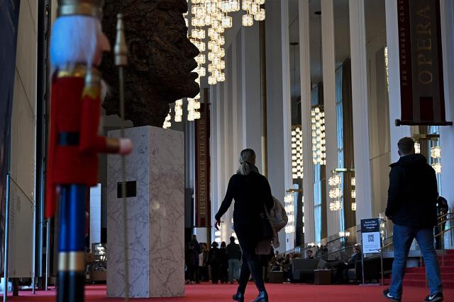 People visit the John F. Kennedy Center for the Performing Arts, which was recently renamed the "Trump Kennedy Center," in Washington, DC,  on December 26, 2025. US President Donald Trump's name was affixed to the Kennedy Center in Washington on December 19, 2025, one day after his hand-picked board members voted to rename the arts venue in spite of legal questions. (Photo by Brendan Smialowski / AFP)