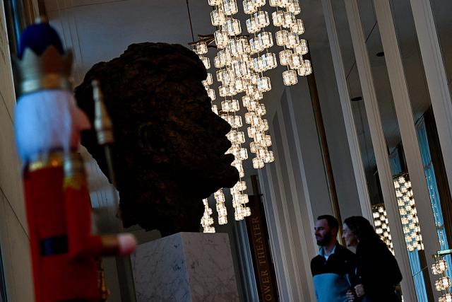 People visit the John F. Kennedy Center for the Performing Arts, which was recently renamed the "Trump Kennedy Center," in Washington, DC,  on December 26, 2025. US President Donald Trump's name was affixed to the Kennedy Center in Washington on December 19, 2025, one day after his hand-picked board members voted to rename the arts venue in spite of legal questions. (Photo by Brendan Smialowski / AFP)