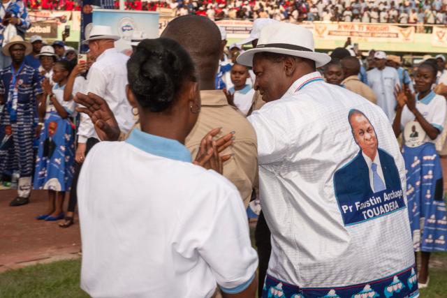 Central African Republic's President and presidential candidate for the United Hearts Movement (MCU) Faustin Archange Touadera (R) arrives for his final rally in Bangui on December 26, 2025 ahead of CAR's presidential election on December 28, 2025. (Photo by Annela NIAMOLO / AFP)