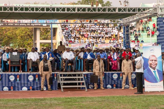 Central African Republic's President and presidential candidate for the United Hearts Movement (MCU) Faustin Archange Touadera (C) sits on stage during his final rally in Bangui on December 26, 2025 ahead of CAR's presidential election on December 28, 2025. (Photo by Annela NIAMOLO / AFP)