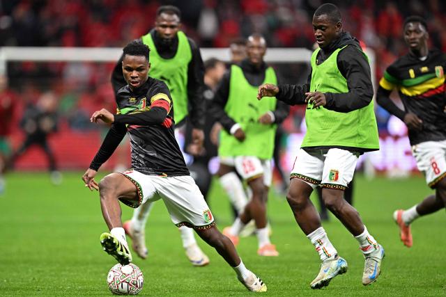 Mali's midfielder #20 Mamadou Sangare and Mali's midfielder #23 Aliou Dieng warm up ahead of the Africa Cup of Nations (CAN) Group A football match between Morocco and Mali at Prince Moulay Abdellah Stadium in Rabat on December 26, 2025. (Photo by Gabriel BOUYS / AFP)