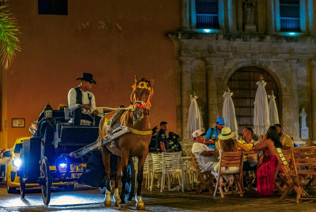 (FILES) A coachman with his horse-drawn carriage tours the historic center of Cartagena, Colombia, on March 07, 2025. Traditional horse-drawn carriages will be banned starting December 29, 2025, in Cartagena, a tourist jewel of Colombia, the local mayor announced on December 26. (Photo by Manuel PEDRAZA / AFP)